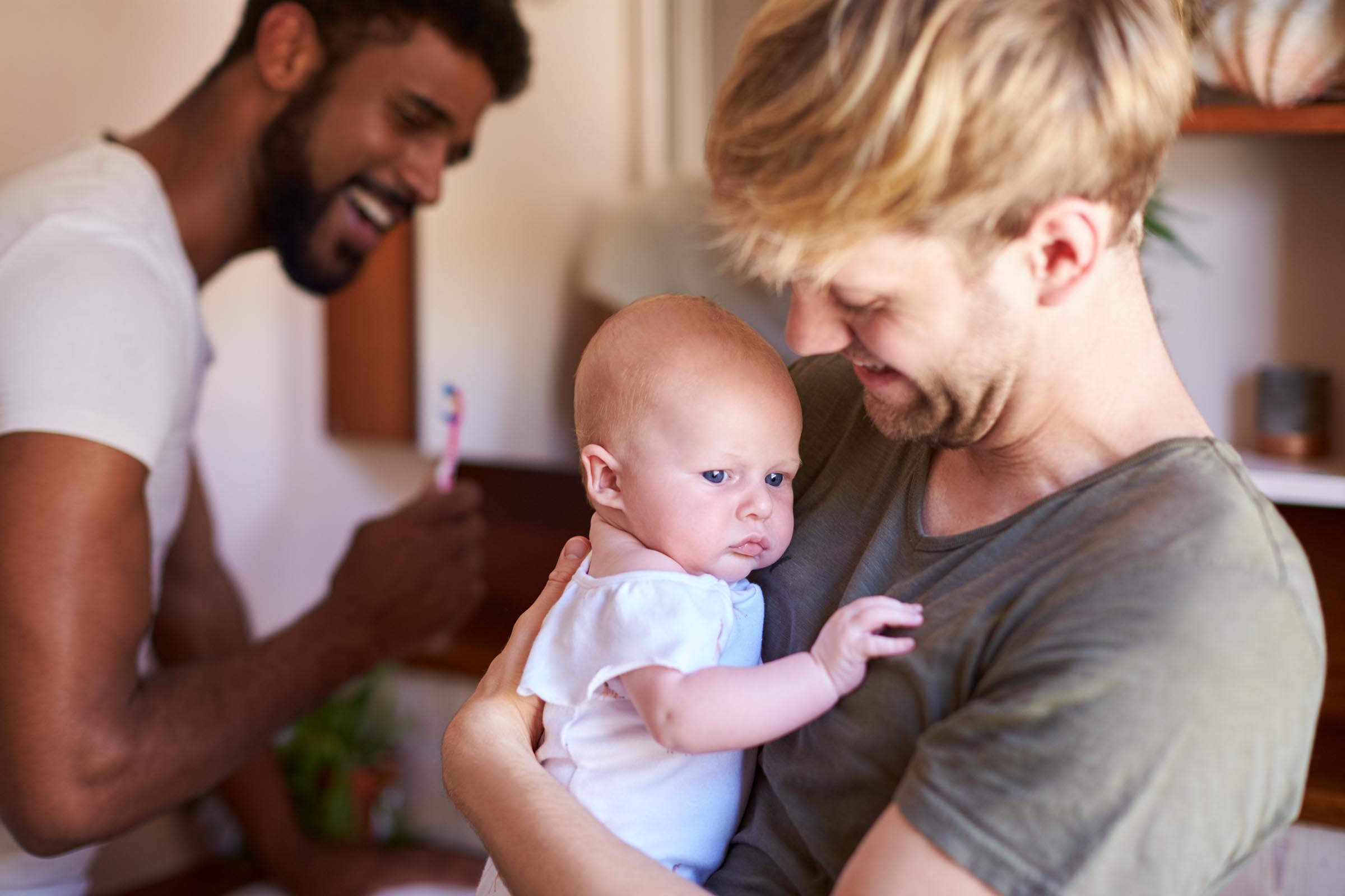 young father hugging his baby happily