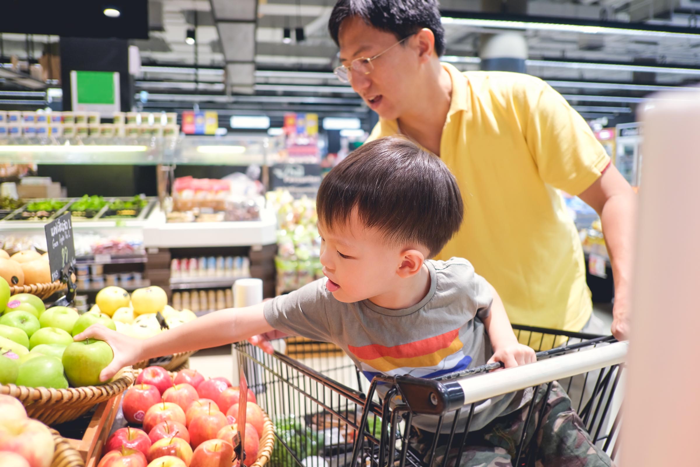 Asian father and son happily shopping