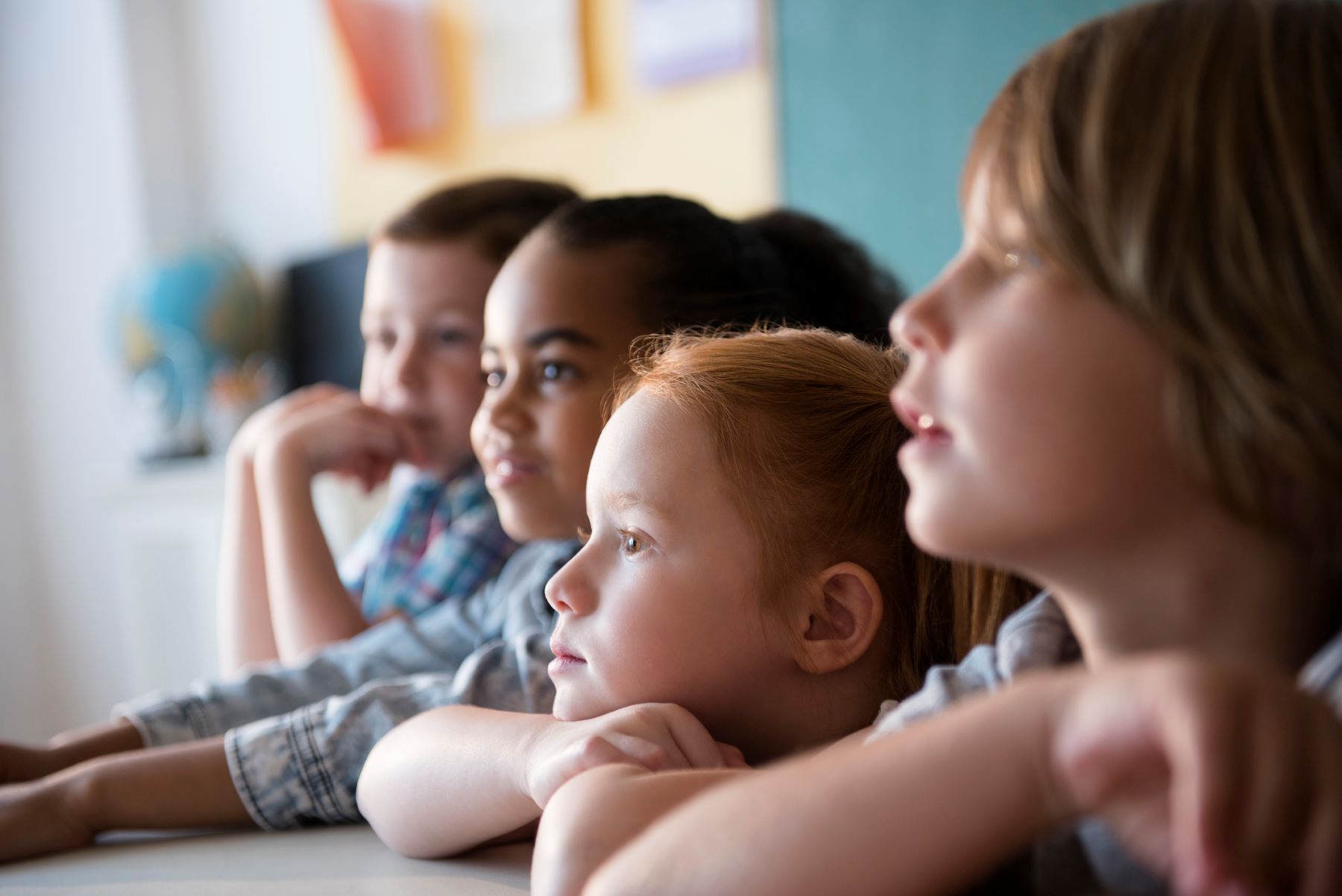 group of children listening in school classroom