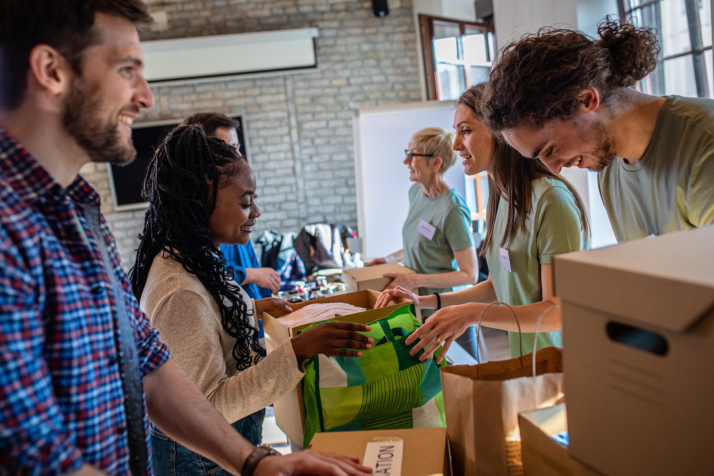 People smiling at clothes donation event