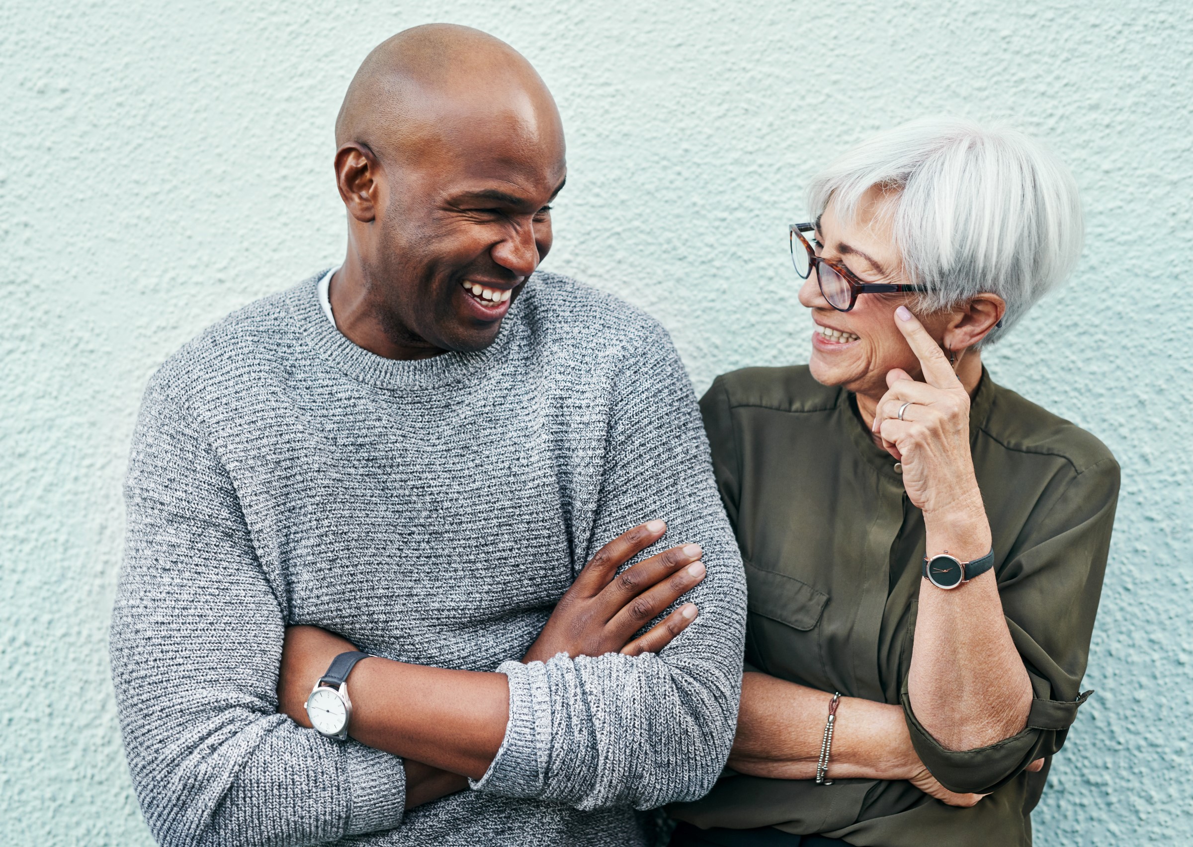 two people standing next to each other smiling