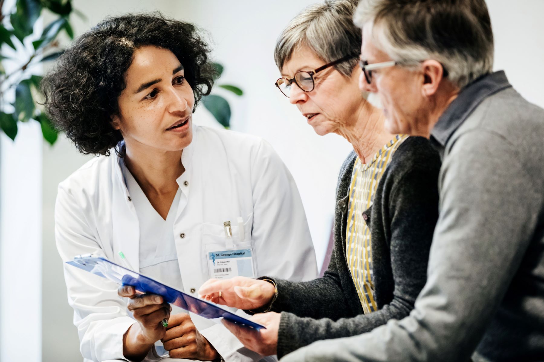 doctor discussing with adult couple