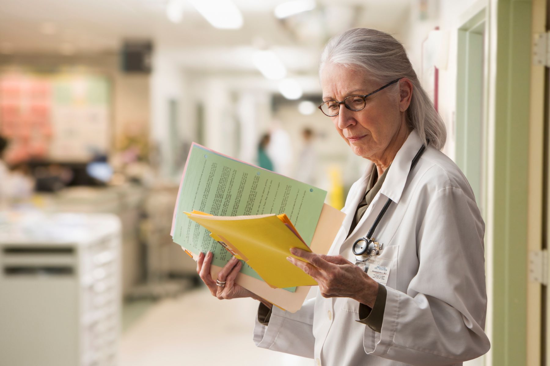 Older female doctor looking at paperwork